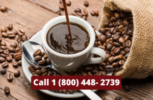 coffee being brewing into a mug in a saucer surrounded by coffee beans