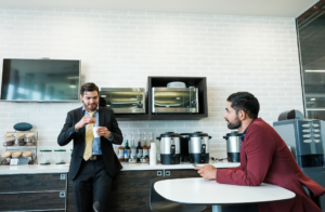 male employees conversing in breakroom